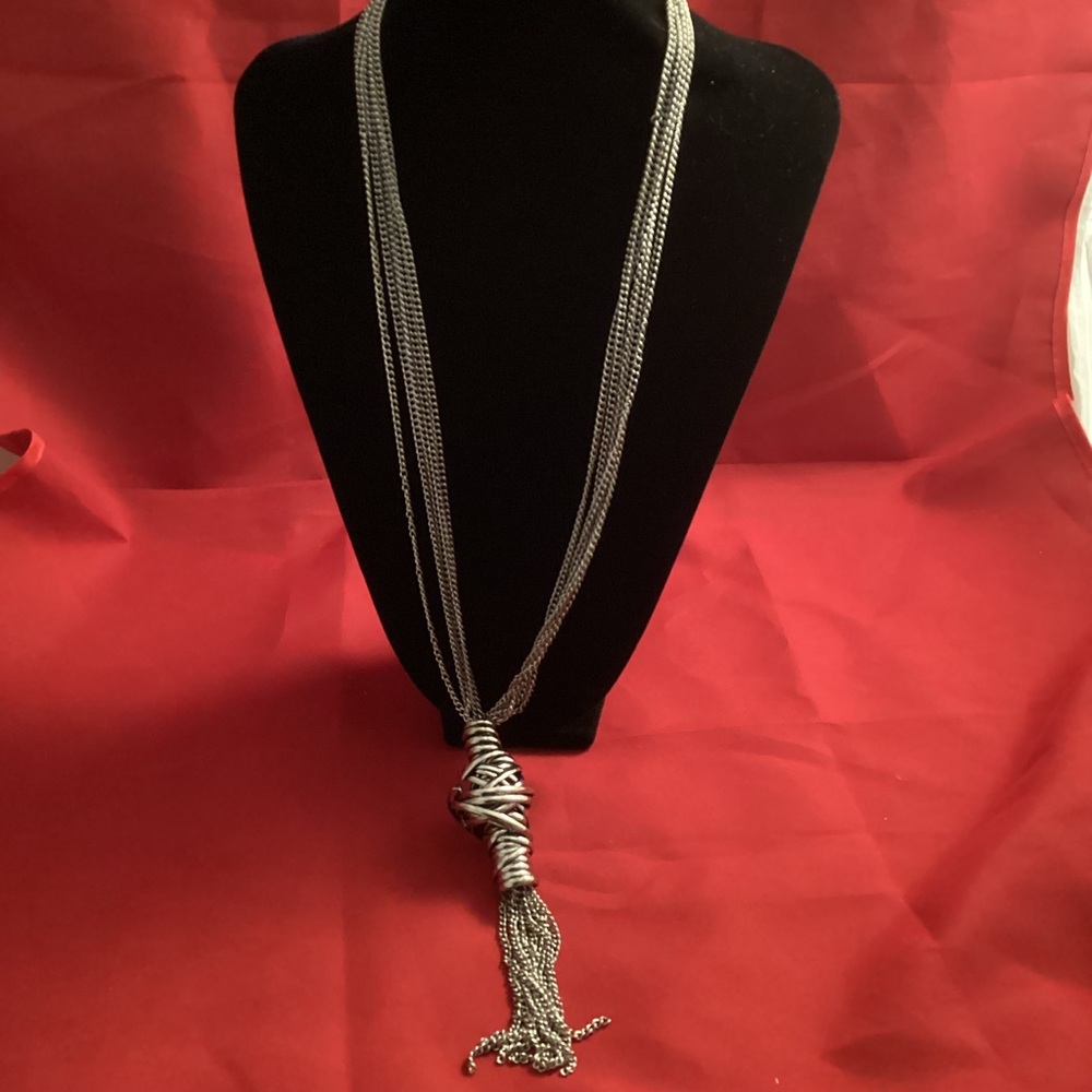 Long silver tone metallic with a big node necklace